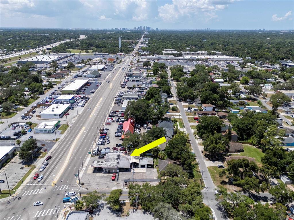 An aerial view shows a commercial building with a flat roof next to a highway — 8624 N FLORIDA AVENUE, TAMPA, FL