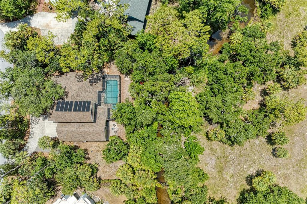 A swimming pool and spa are enclosed by a screened lanai next to a house — 5911 RIVER FOREST CIRCLE, BRADENTON, FL