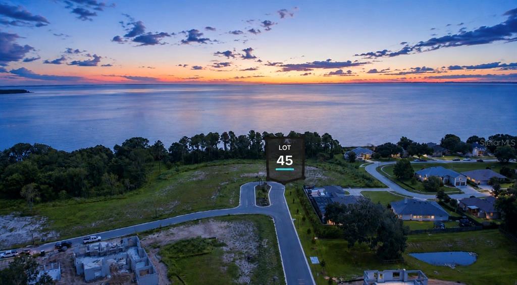 This aerial view shows a vacant residential lot labeled 45 overlooking a large body of water — 552 WALKER STREET, OAKLAND, FL