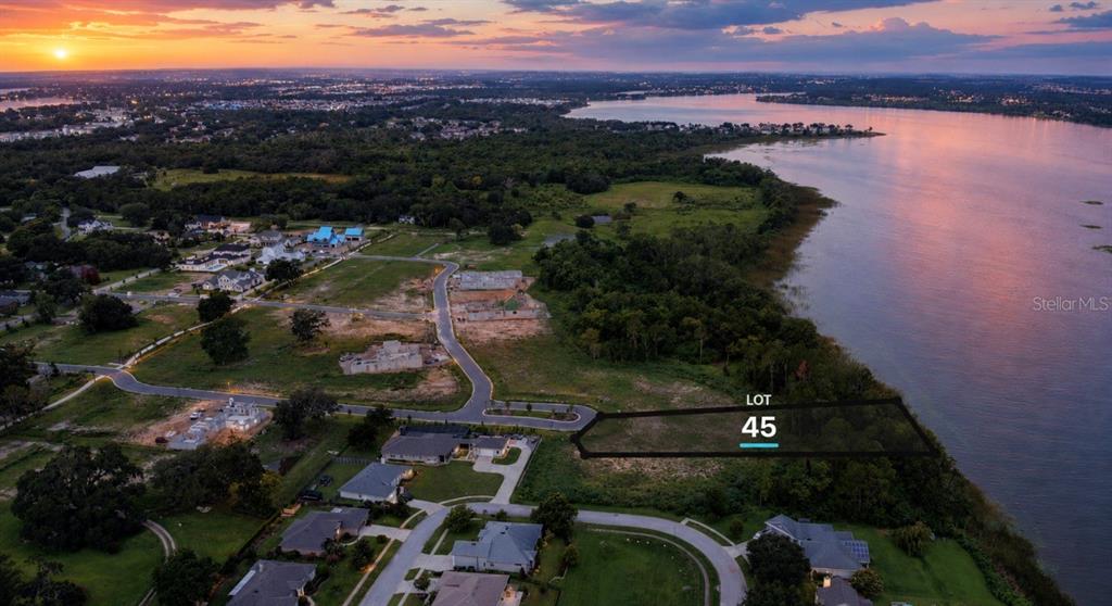 An aerial view shows a vacant waterfront lot labeled 45 in a residential development — 552 WALKER STREET, OAKLAND, FL