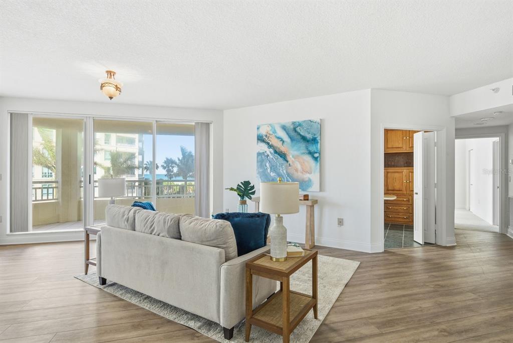 An entryway features double wooden doors, a light blue bench, and a floral wall painting — 1170 SE GULF BOULEVARD UNIT 305, CLEARWATER BEACH, FL