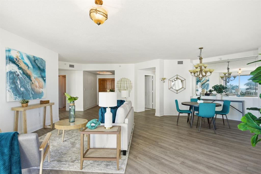 A living room with light wood floors, a sofa, and a balcony overlooking the ocean — 1170 SE GULF BOULEVARD UNIT 305, CLEARWATER BEACH, FL