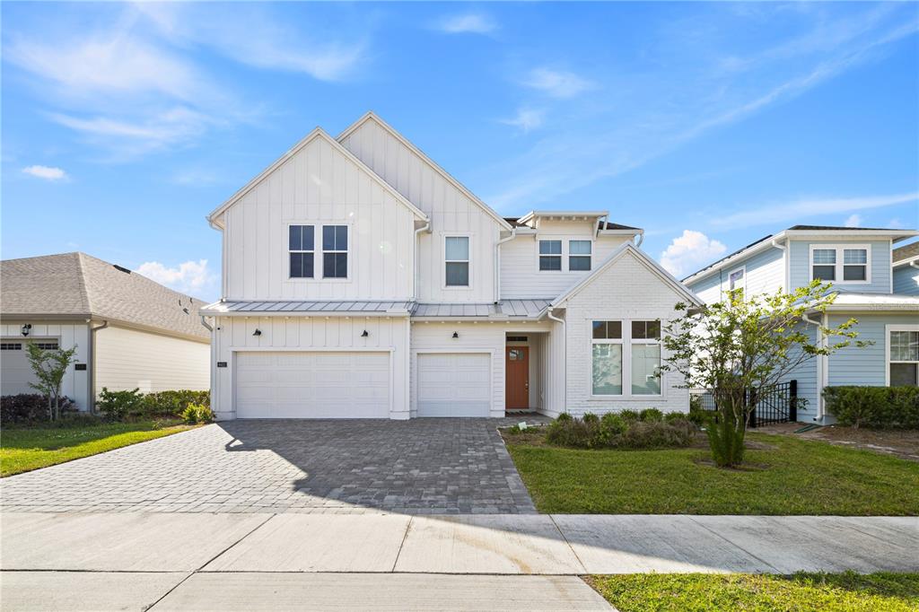 The back exterior of a two-story house features a covered patio and a swimming pool — 6422 TRAILBLAZE BEND, ST CLOUD, FL