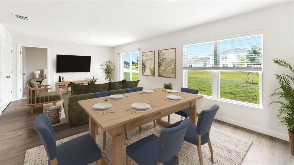 This rendering shows a dining area and living room with wood-look flooring and large windows — 131 HEIRLOOM DRIVE, ORMOND BEACH, FL