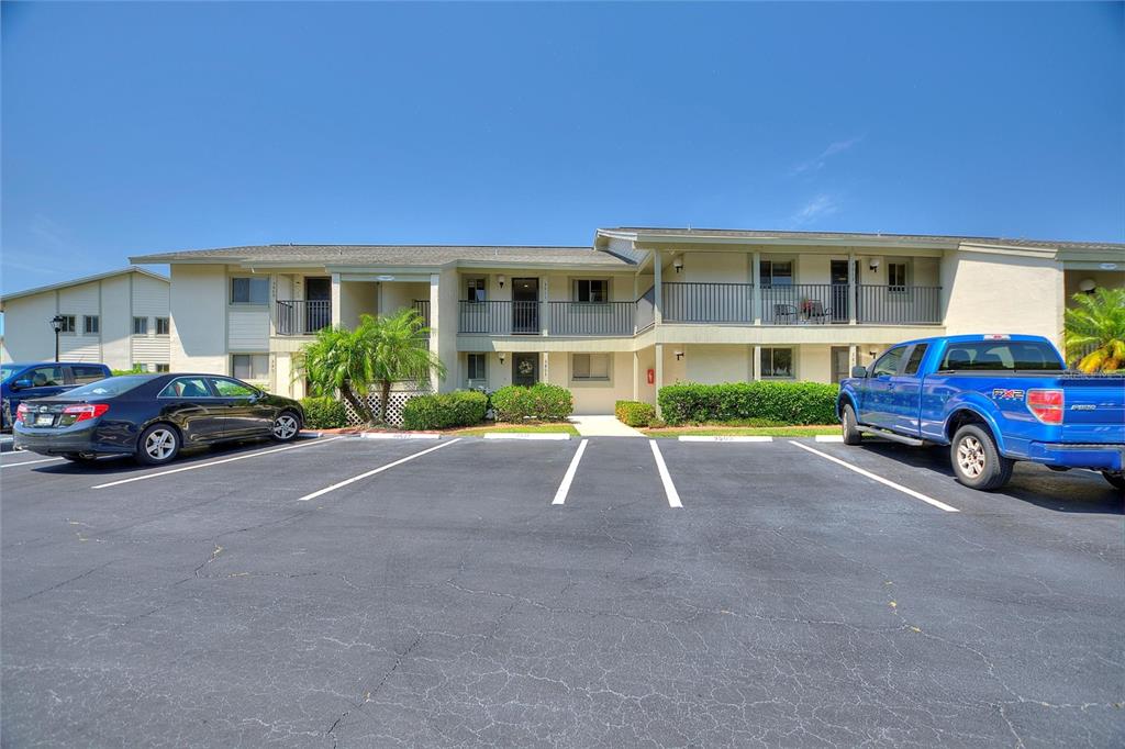 A two-story apartment building with a parking lot in the foreground — 3511 EDGEWATER DRIVE UNIT 3511, SEBRING, FL