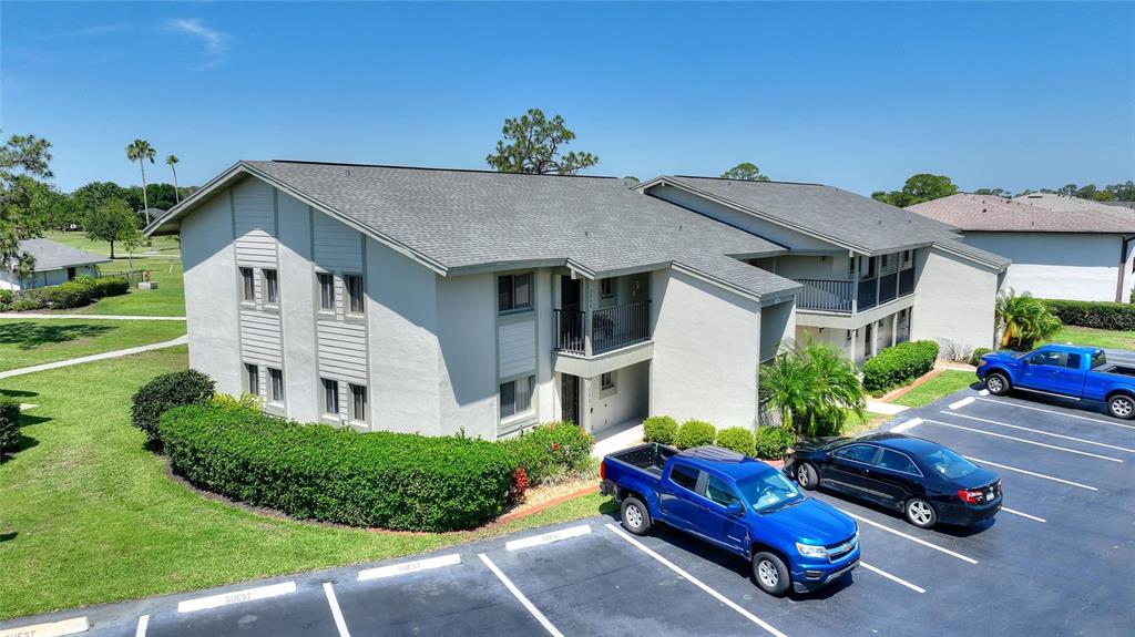 An aerial view shows a two-story apartment building with a parking lot in front — 3511 EDGEWATER DRIVE UNIT 3511, SEBRING, FL