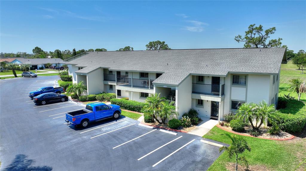 An aerial view shows a two-story apartment building with a parking lot in front — 3511 EDGEWATER DRIVE UNIT 3511, SEBRING, FL