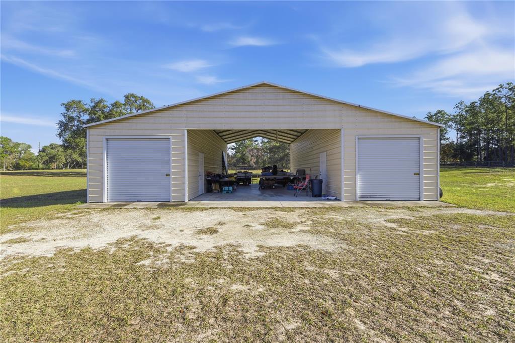 An aerial view of a house exterior with a stone-accented facade and double front doors — 6081 W PELL PLACE, DUNNELLON, FL