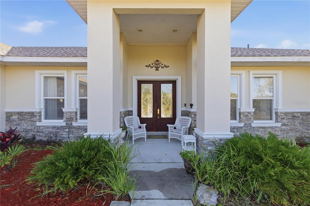 A detached metal garage with two roll-up doors and a central open-air bay — 6081 W PELL PLACE, DUNNELLON, FL