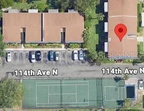 This aerial map view shows two apartment buildings, a parking lot, and a tennis court — 11412 8TH ST N UNIT 1001, ST PETERSBURG, FL