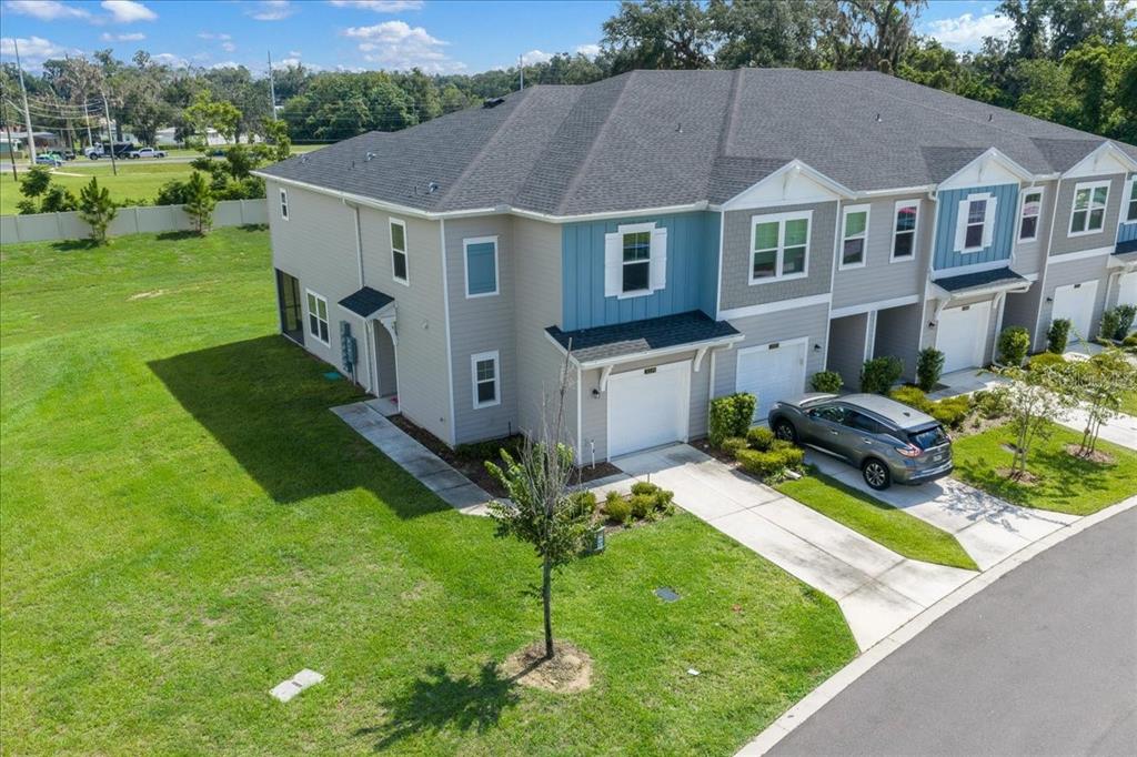 An aerial view of a multi-unit townhouse building with gray siding and a gray roof — 3339 SE 37TH AVENUE ROAD, OCALA, FL