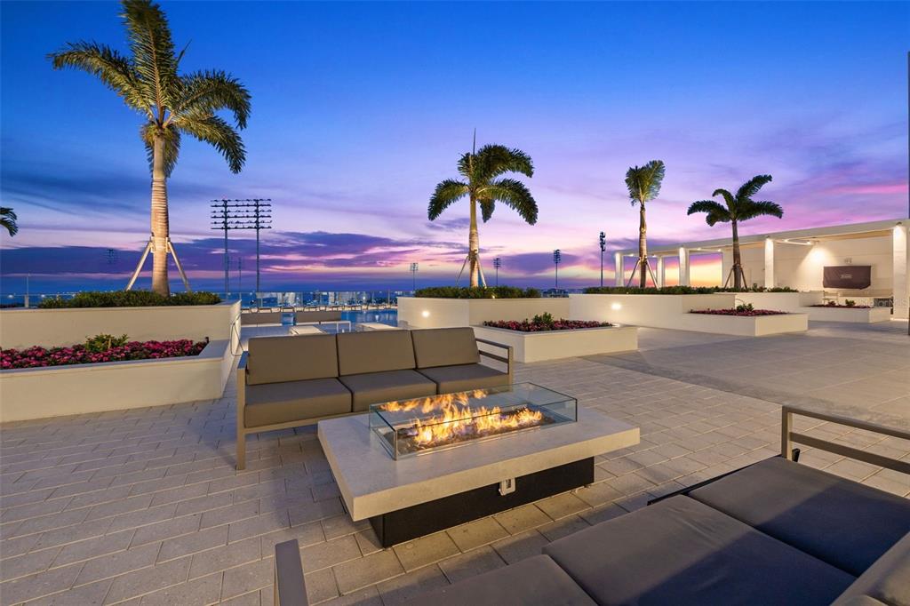 A tall residential high-rise building features balconies and a swimming pool in the foreground — 301 1ST STREET S UNIT 1505, ST PETERSBURG, FL