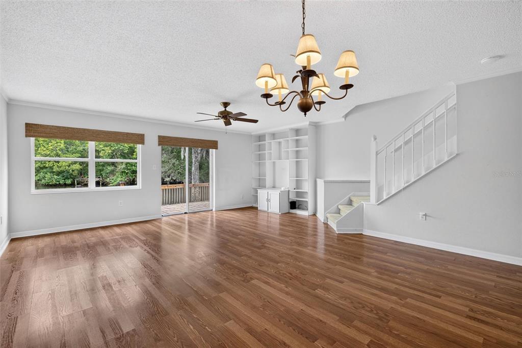 A front porch with a white door, a red wreath, two wooden chairs, and a plant — 525 LAKE BRIDGE DRIVE, ORMOND BEACH, FL