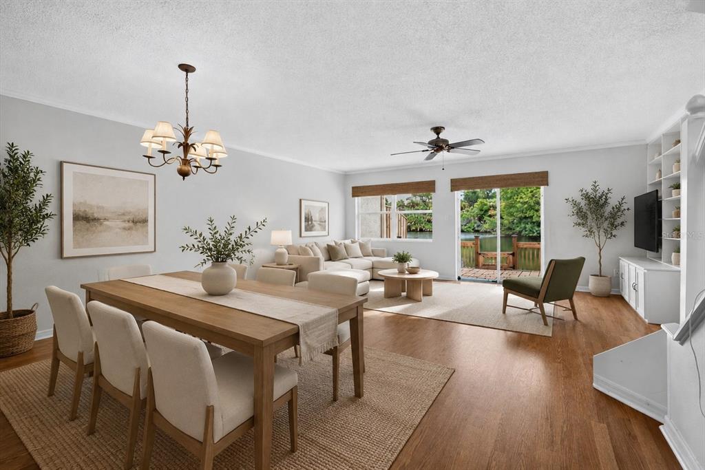 A hallway with wood flooring leads to a living area, adjacent to a wallpapered bathroom — 525 LAKE BRIDGE DRIVE, ORMOND BEACH, FL