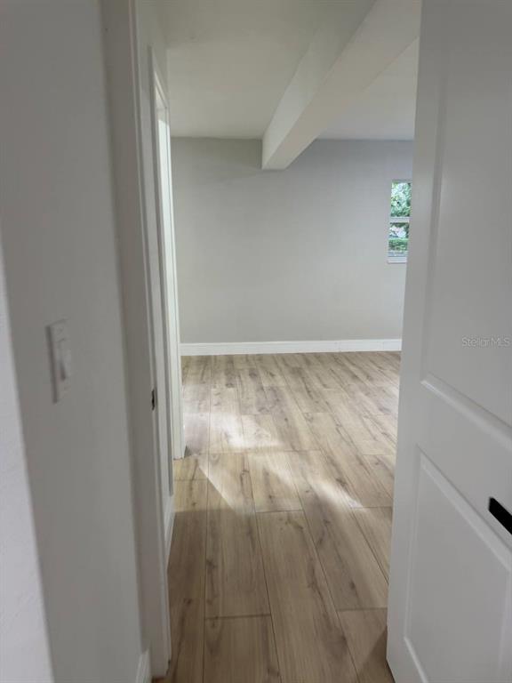 A view through a doorway into a room with light wood-look flooring and gray walls — 924 VALMAR ST, BRANDON, FL