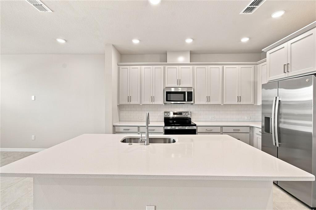 This image is a design board displaying samples of cabinets, quartz, tile, carpet, and paint — 5592 COOPERS HAWK CT, ST CLOUD, FL