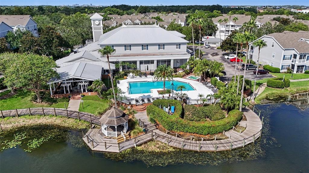 An aerial view shows a community clubhouse with a pool, gazebo, and wooden boardwalk — 5144 CITY STREET UNIT 233, ORLANDO, FL
