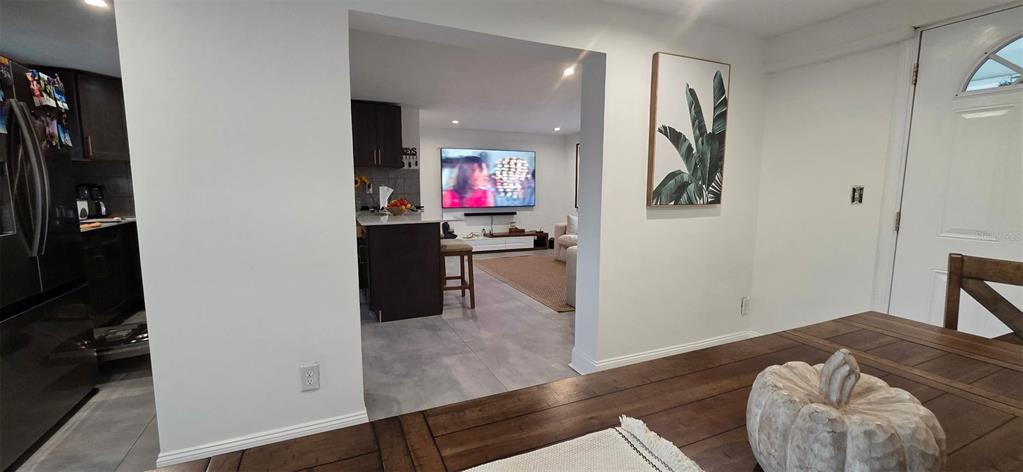 A dining area in the foreground opens into a kitchen and living room space — 146 MARSELLA ROAD, DEBARY, FL