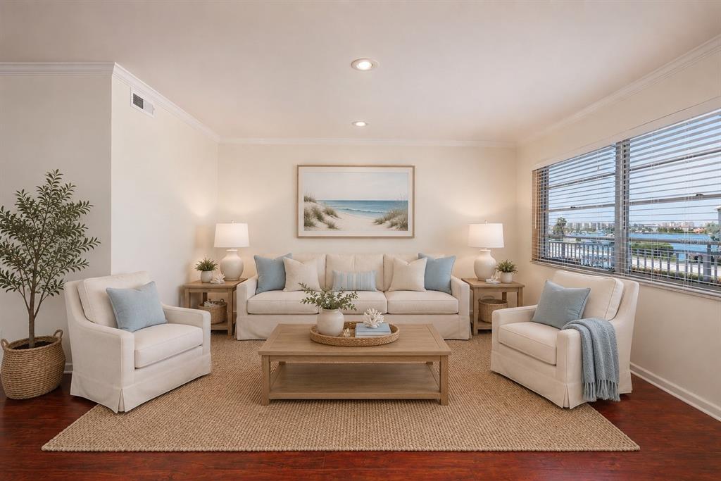 A living room features a beige sofa, two armchairs, a coffee table, and a coastal painting — 1893 SHORE DRIVE S UNIT 209, SOUTH PASADENA, FL