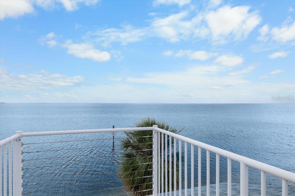 A white metal railing overlooks a calm body of water under a blue sky — 3200 GULF WINDS CIRCLE, HERNANDO BEACH, FL