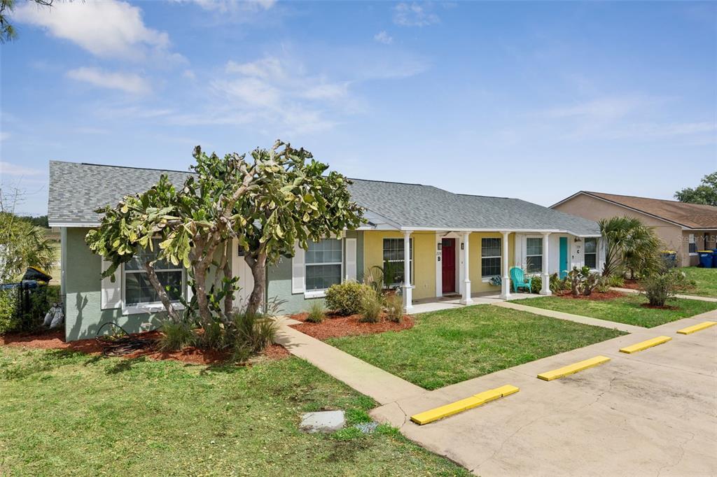 A single-story multi-unit building with a large cactus in the front yard — 220 RIDGECREST LOOP, MINNEOLA, FL