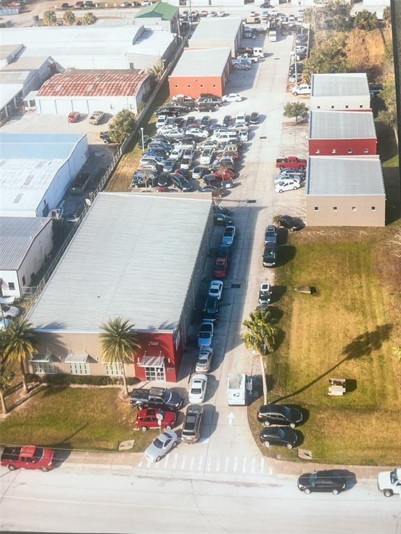 A single-story commercial building with a gray facade, large windows, and a grassy front lawn — 145 RONNING WAY, LONGWOOD, FL