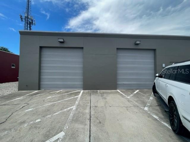A gray commercial building features a parking lot filled with several parked vehicles — 145 RONNING WAY, LONGWOOD, FL