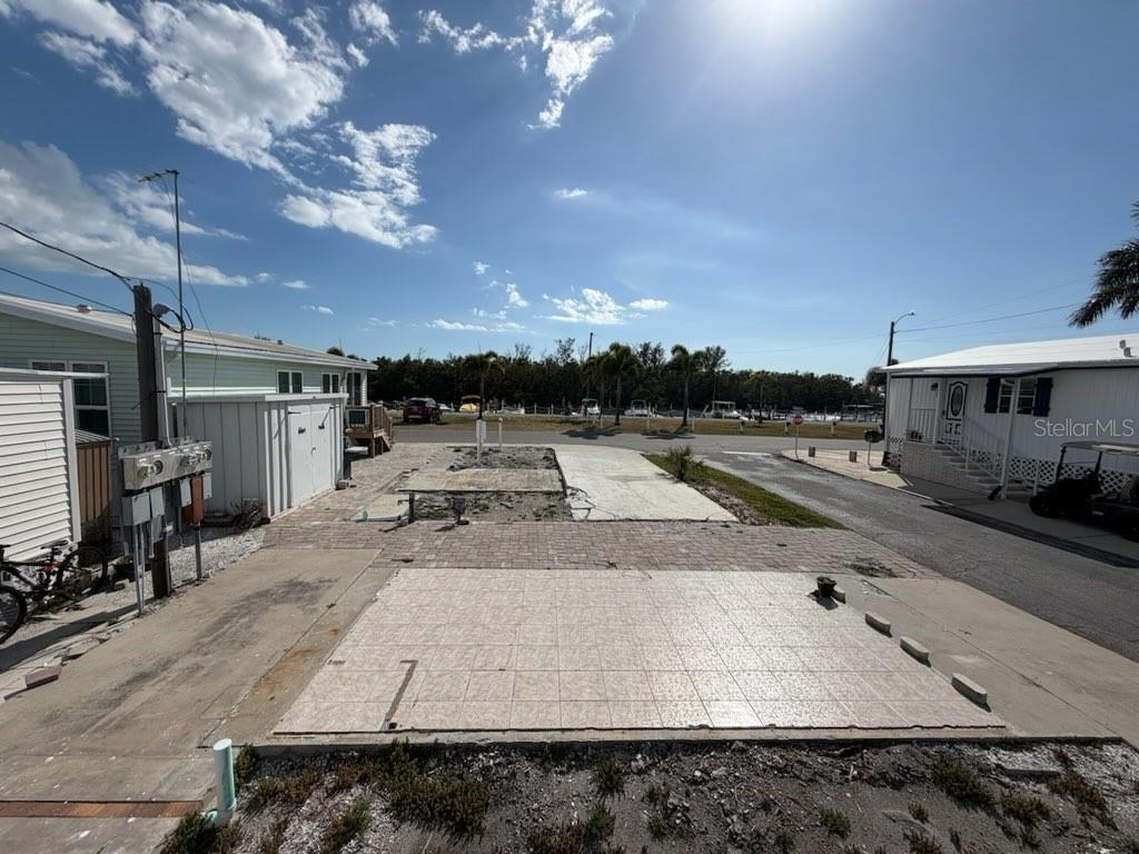 An outdoor lot features a paved patio area, a concrete slab, and a utility shed — 10315 CORTEZ ROAD W UNIT 2-4, BRADENTON, FL