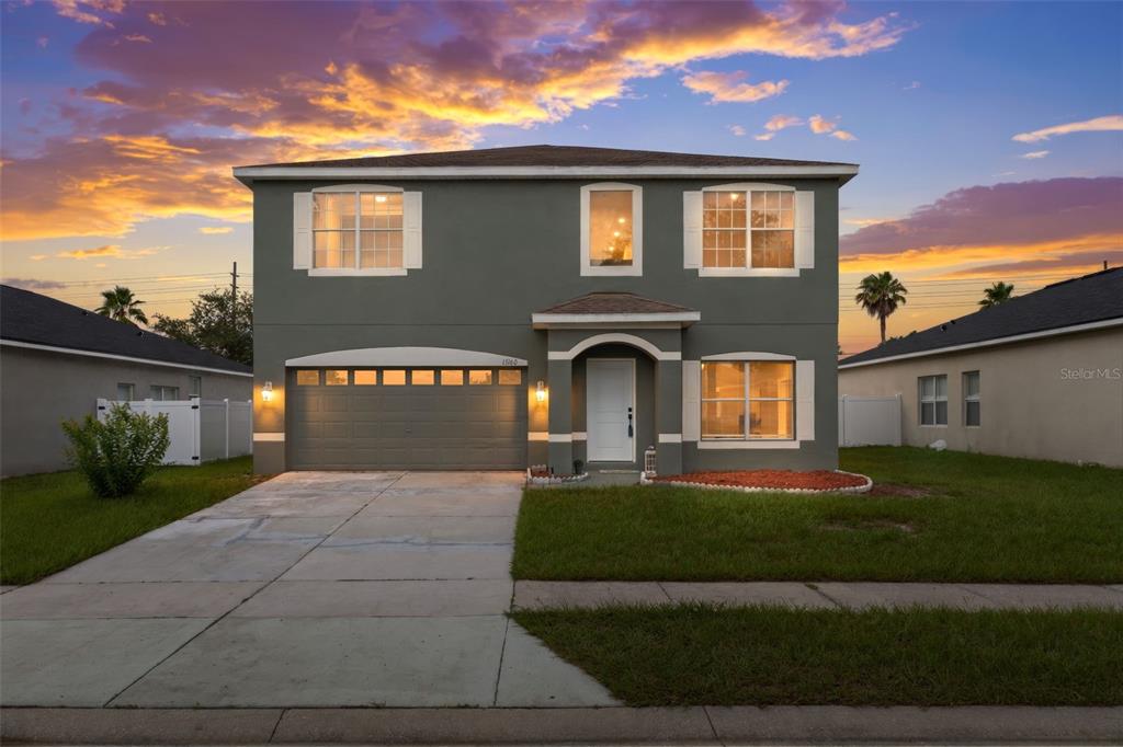 A two-story house with a gray exterior, a two-car garage, and a concrete driveway — 15160 DURANGO CIRCLE, BROOKSVILLE, FL