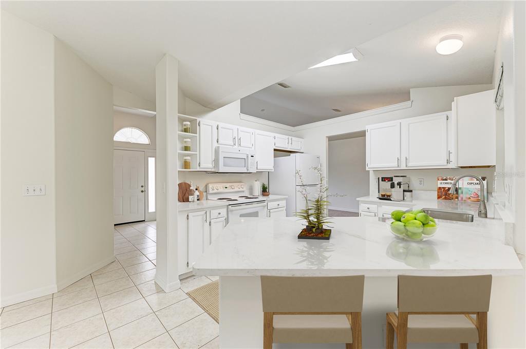 A single-story house with a beige stucco exterior, palm trees, and a green lawn — 3213 45TH AVENUE E, BRADENTON, FL