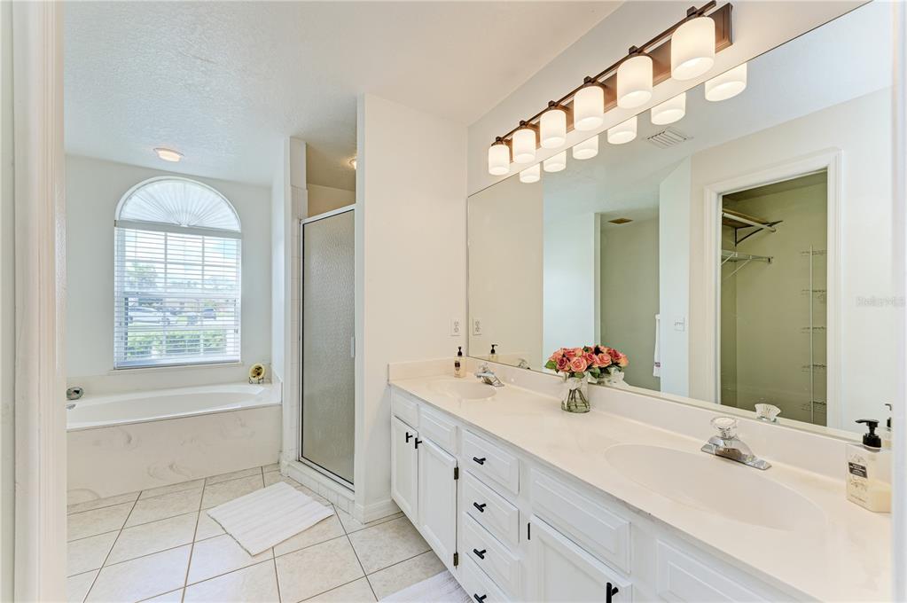 A single-story house with a beige stucco exterior, a two-car garage, and a concrete driveway — 3213 45TH AVENUE E, BRADENTON, FL