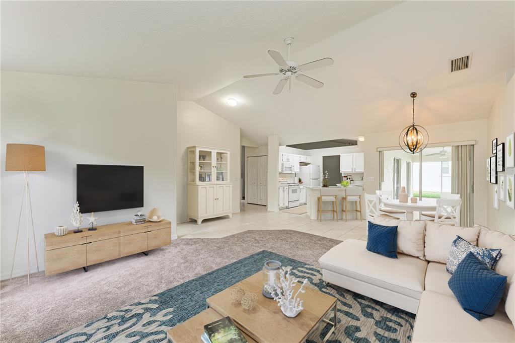A single-story house with a beige stucco exterior, arched entryway, and a green front lawn — 3213 45TH AVENUE E, BRADENTON, FL