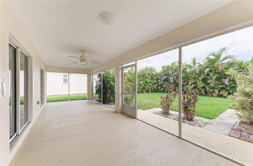 A beige single-story house exterior features a covered entryway, a two-car garage, and arched windows — 3213 45TH AVENUE E, BRADENTON, FL