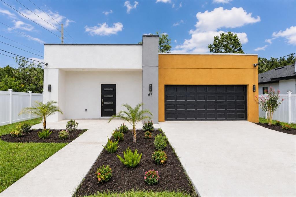 A modern living room features a gray sectional sofa, a coffee table, and white tile floors — 67 W 10TH STREET, APOPKA, FL