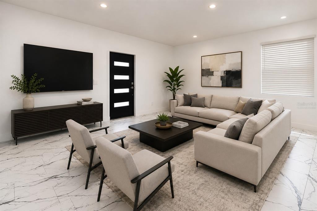 A long hallway with white walls and white marble-patterned tile flooring leads to a sliding door — 67 W 10TH STREET, APOPKA, FL
