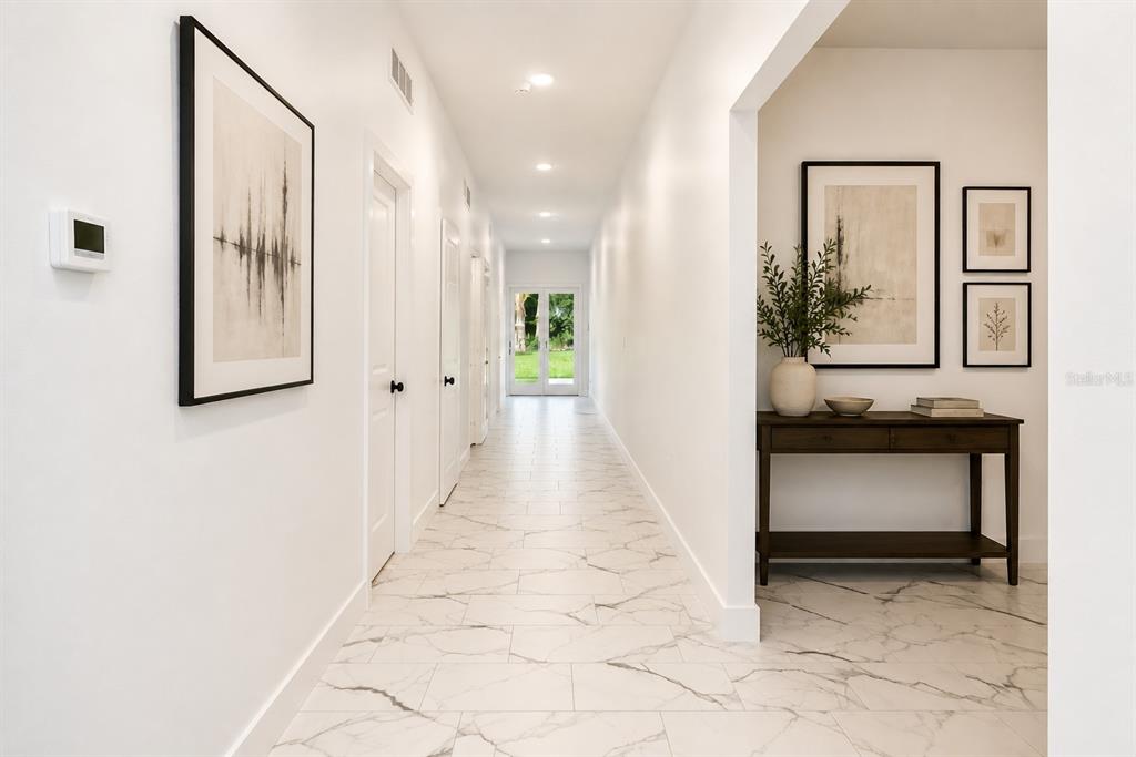 A home office features a white desk, marble-patterned tile flooring, and two tall shelving units — 67 W 10TH STREET, APOPKA, FL