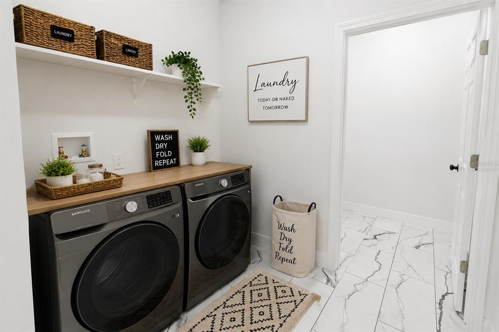 A small bathroom features a white toilet, a dark vanity with a vessel sink, and marble-look flooring — 67 W 10TH STREET, APOPKA, FL