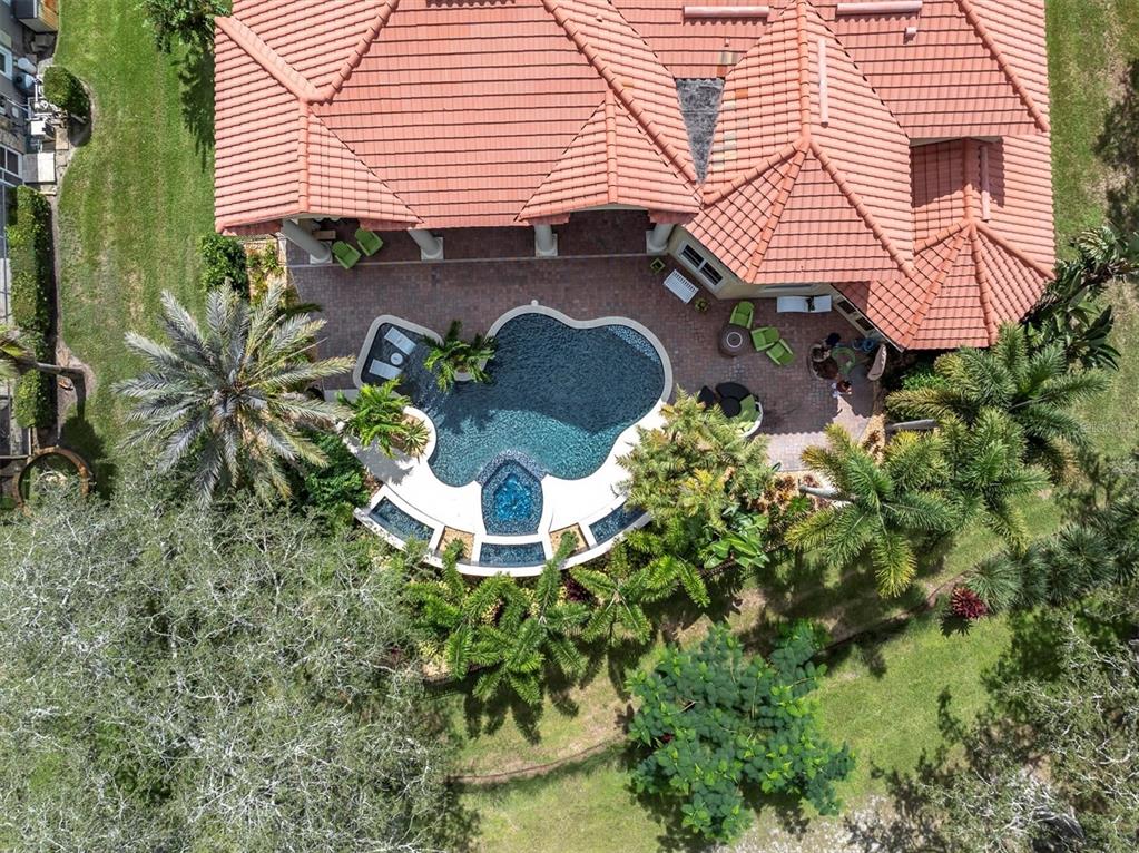 An aerial view shows a house with a red tile roof and a backyard pool — 2861 ROEHAMPTON CLOSE, TARPON SPRINGS, FL