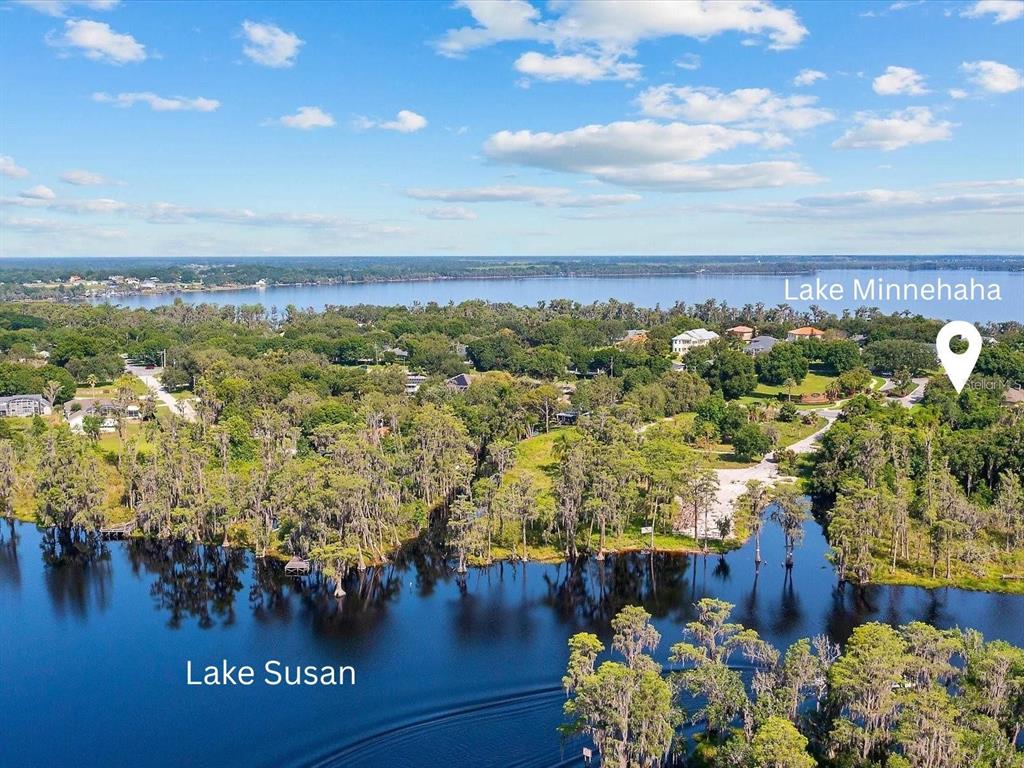 An aerial view shows Lake Susan in the foreground and Lake Minnehaha in the distance — 11812 OSPREY POINTE BOULEVARD, CLERMONT, FL