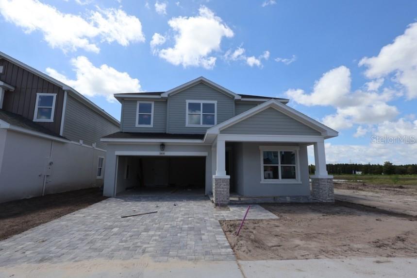A two-story house with a paved driveway, a two-car garage, and a covered front porch — 2835 SOLETA VIEW, ODESSA, FL