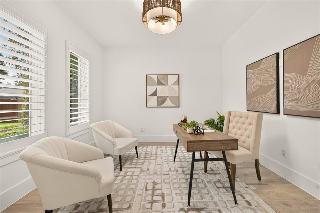 A home office features a desk, two armchairs, a rug, and wall art — 2343 VERSAILLES AVENUE, WINTER PARK, FL