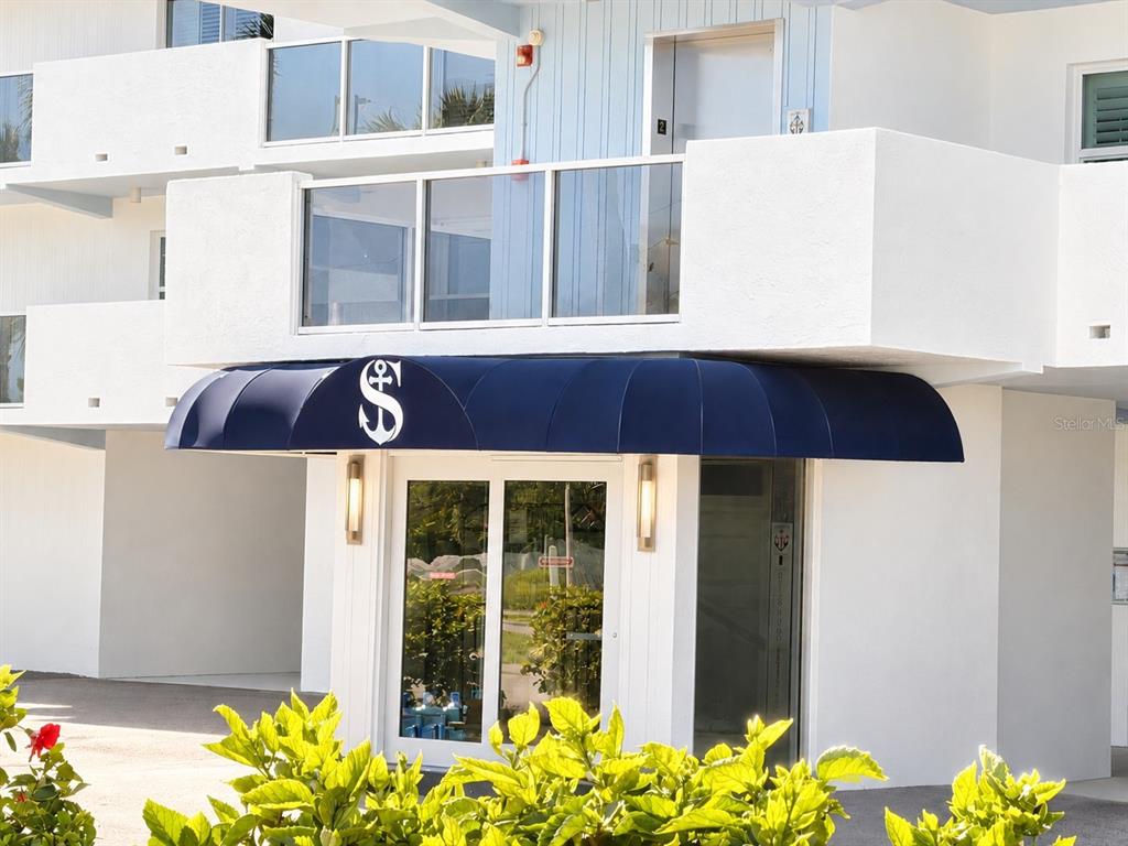 A multi-story apartment building with covered parking on the ground level and exterior balconies — 1100 PINELLAS BAYWAY S UNIT G2, TIERRA VERDE, FL