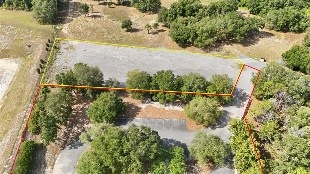 An aerial view shows a building with a playground and parking lot on a lot — 20540 INDEPENDENCE BOULEVARD, GROVELAND, FL