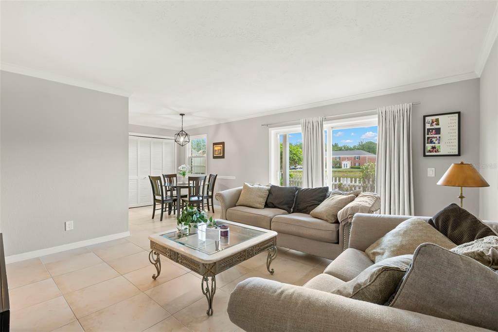 An aerial view of a two-story apartment building with a parking lot and pond — 13762 ORANGE SUNSET DRIVE UNIT 102, TAMPA, FL