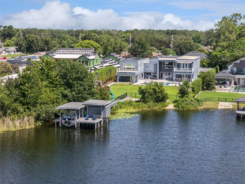 An aerial view of a waterfront house with a private dock and a swimming pool — 8922 UNIVERSITY BOULEVARD, ORLANDO, FL