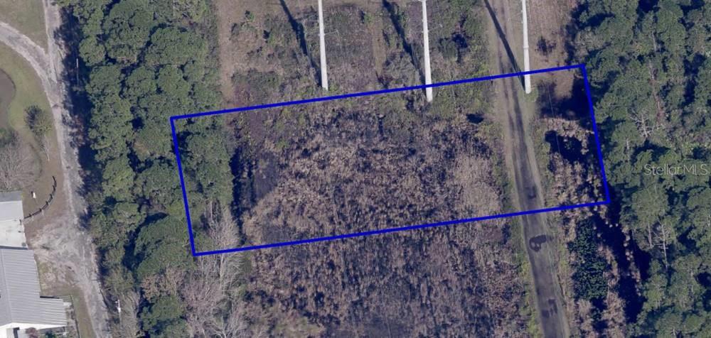 This aerial map shows a rectangular plot of land bordered by trees and utility poles — TBD RAYBURN ROAD, COCOA, FL