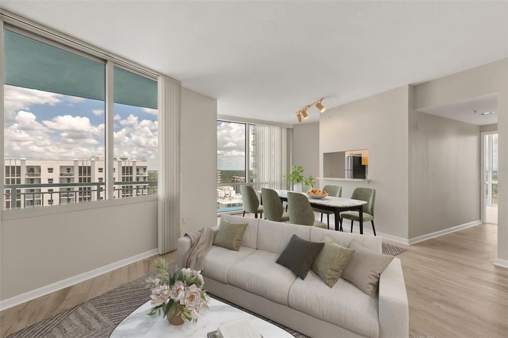 A bright living and dining area with floor-to-ceiling windows and light wood-look flooring — 322 E CENTRAL BOULEVARD UNIT 1910, ORLANDO, FL