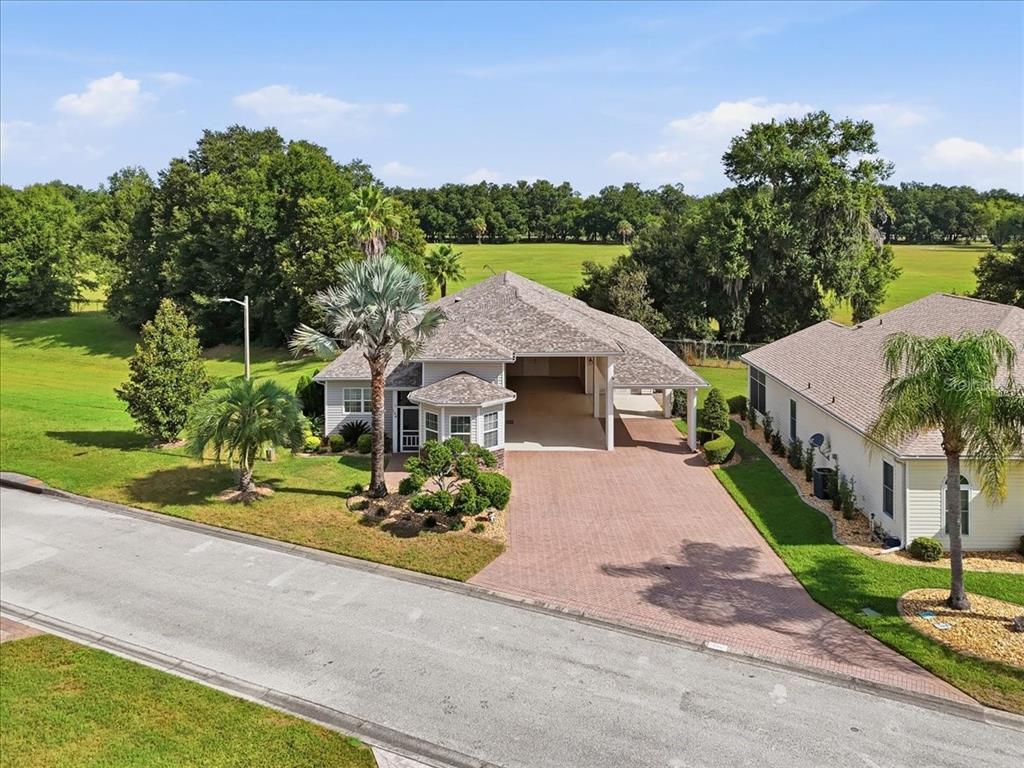 An aerial view of a suburban house with a brick driveway and a large garage — 194 LAYNEWADE ROAD, POLK CITY, FL