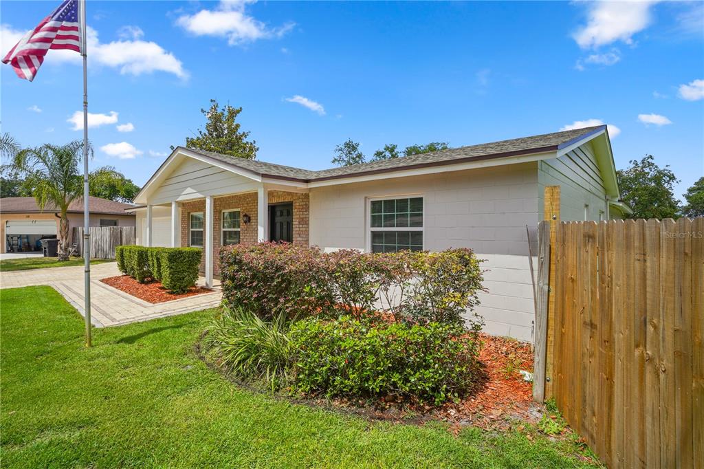 A single-story house with a brick and light-colored siding exterior, a front yard, and a fence — 110 DEVON COURT, LONGWOOD, FL