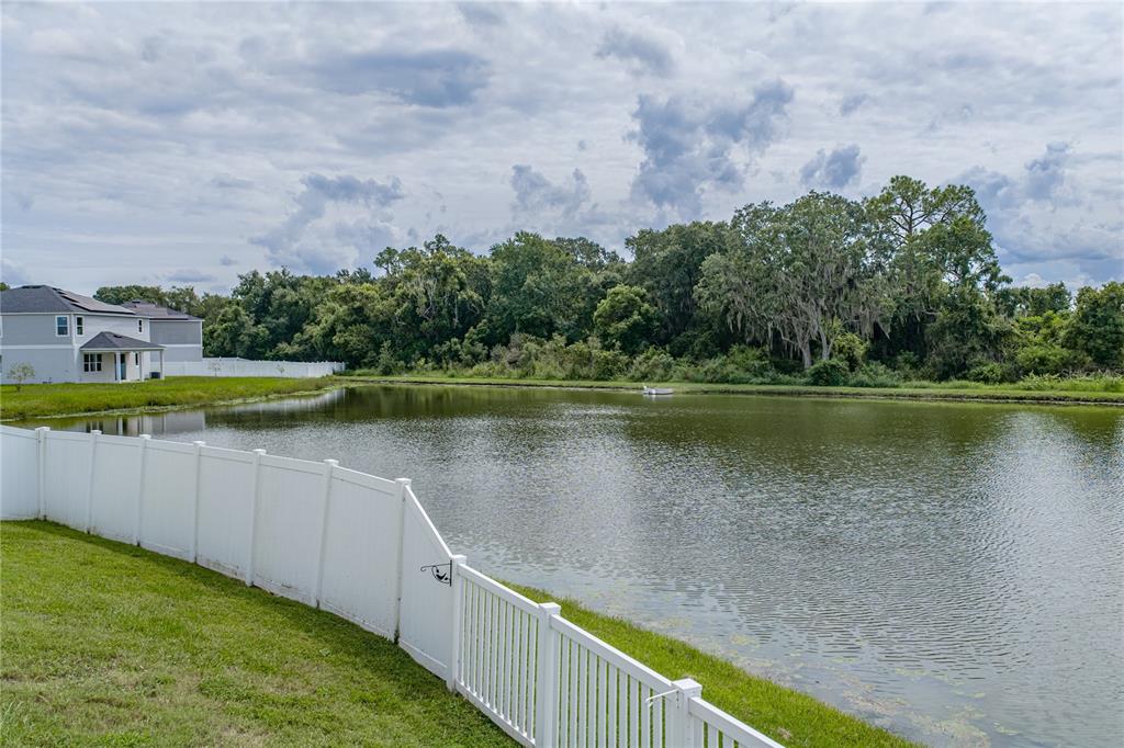 A single-story house with a brown garage door, beige stucco walls, and a grassy lawn — 1444 MATTIE POINTE LANE, AUBURNDALE, FL